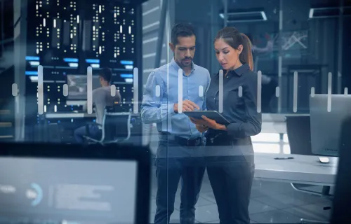 Cybersecurity operations center team looking at a tablet 