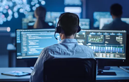 An engineer in a computer lab with colleagues