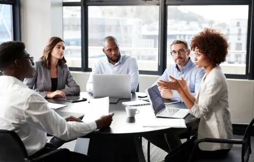 Digital Backbone consultants in discussion around table