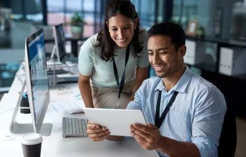 Digital workplace consultants look at tablet together