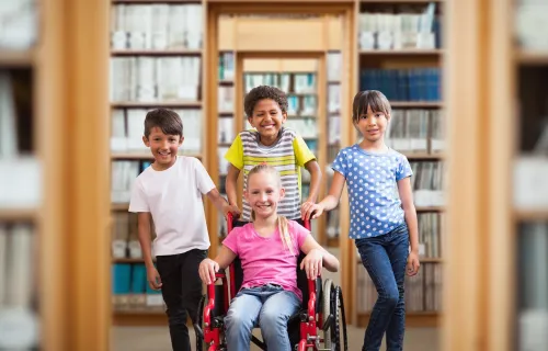 A diverse group of children posing together in a library