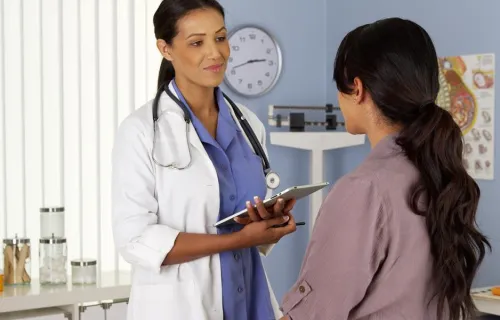 Doctor with clipboard has a consultation with a patient