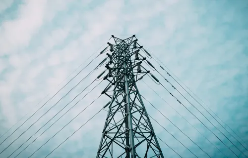 close up of an electricity pylon against background of blue sky