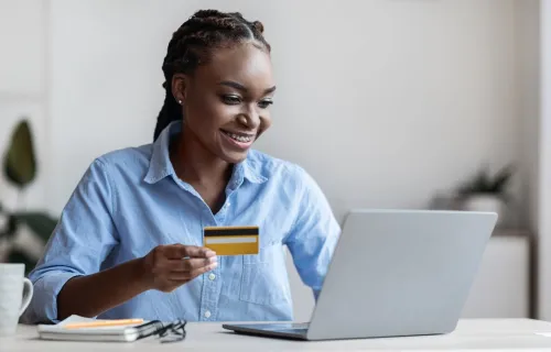 Woman entering payment details on a laptop