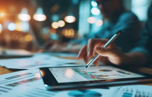 A personal analyzing financial data on a tablet
