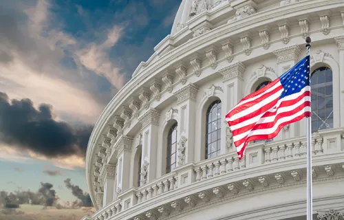 a shot of the U.S. Capital building with an American flag flying
