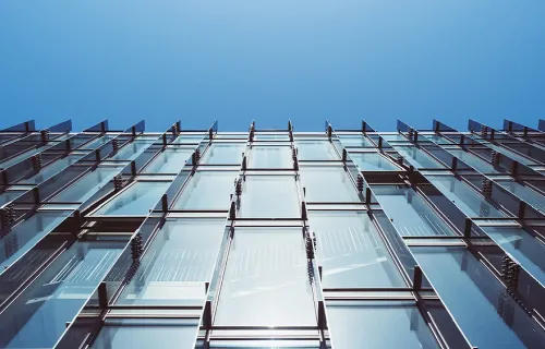View of glass window panes on a building and blue sky