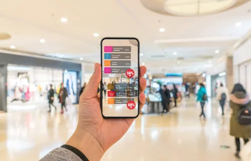 Hand holding smart phone with AR application to check information