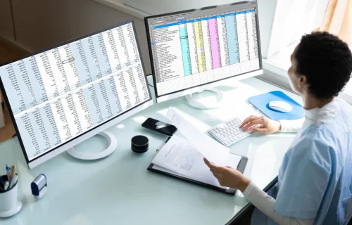 healthcare worker looking at data on a computer