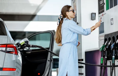 Female filling her car with fuel