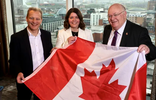 CGI's Lindsay McGranaghan holding Canadian flag with event stakeholders