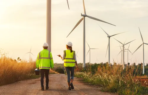 Workers in high visibility jackets at a wind farm