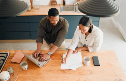 man and woman working on finances