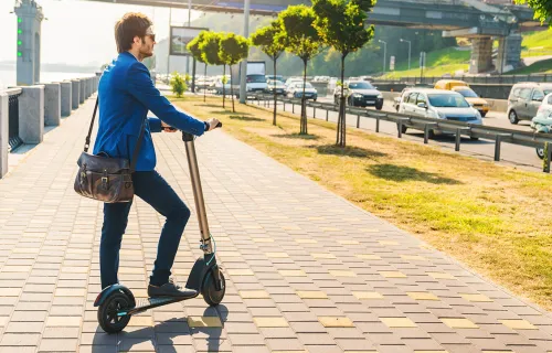 Young man on e-scooter in a modern city