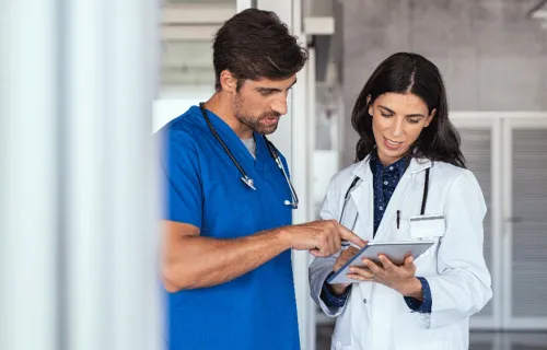 Two doctors looking at a tablet