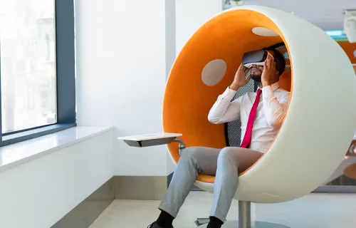 Person in VR headset in orange and white chair