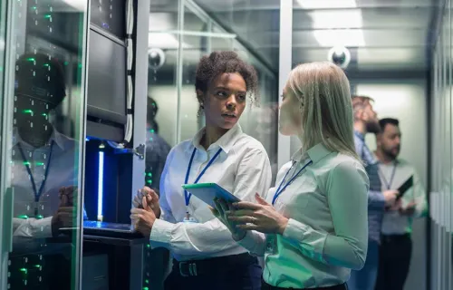 Two consultants in a server room 