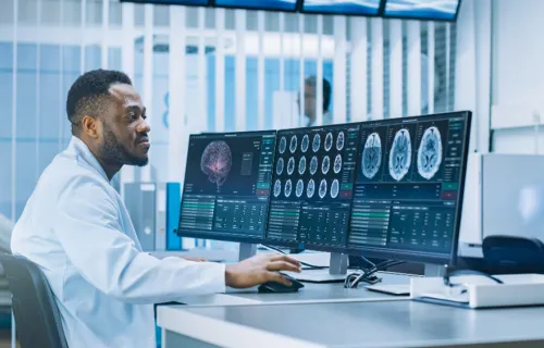 Clinician looking at brains scans on a computer