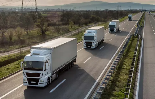 Fleet of lorries driving on a motorway