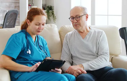 Healthcare worker shows patient data on tablet