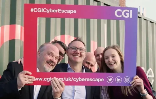 People holding up a selfie frame outside the CGI Cyber Escape in Bolton