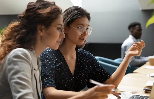 two women looking at a laptop together