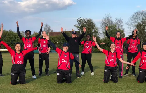 women's sports team wearing CGI sponsored kit posing for socially distanced team photo on pitch