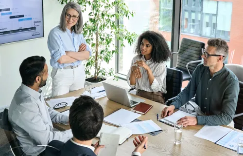 Working professionals sit together to collaborate and share ideas