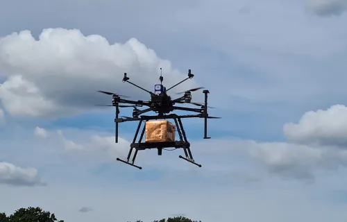 drone flying with box parcel in the air
