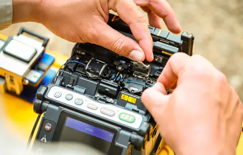 Technician checking fibre optic device