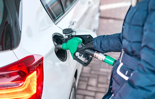 Fuel retail customers puts fuel into vehicle