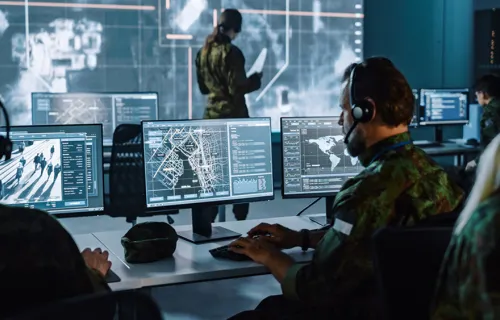 Soldiers in control room using technology to track data