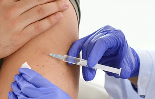 Nurse administers COVID-19 vaccine to patient