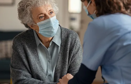 nurse helping elderly patient at home