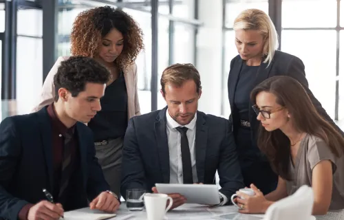 A group of professionals reading a document together