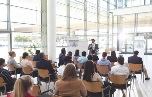 People sat at a conference listening to speaker