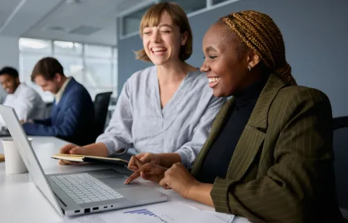 People working together in front of a laptop