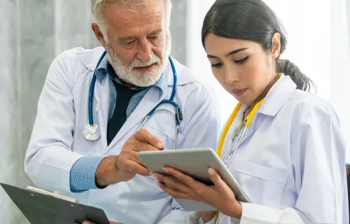 Physicians reviewing data on a tablet