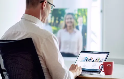 Post-quantum cryptography consultant looks at CGI website on laptop
