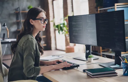 Professional working in two monitors