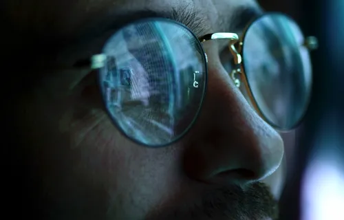 Reflection of computer screen in persons glasses