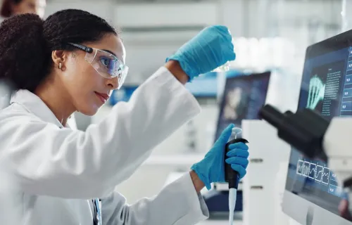 Female scientist working with a vial in a laboratory