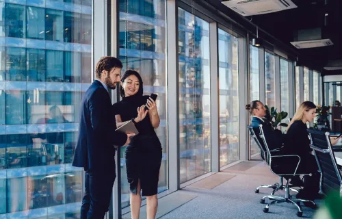 SIAM consultants in office looking at phone together