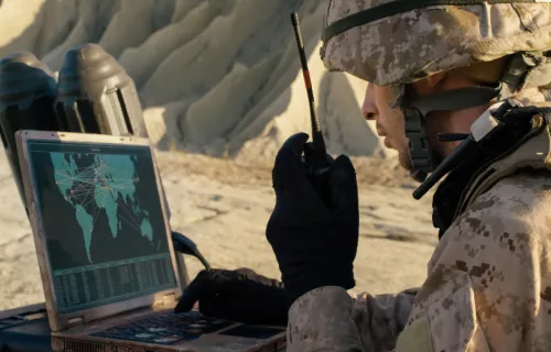 Marine using ruggedized laptop in combat zone