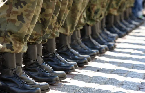 a line of soldiers shown from calves down