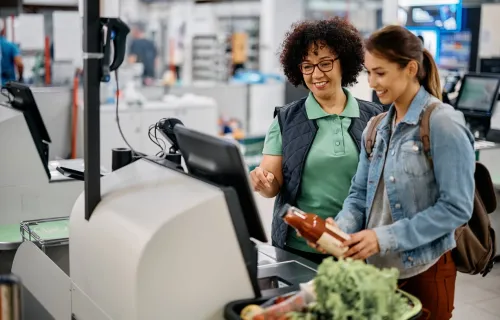 Super market employee helps customer