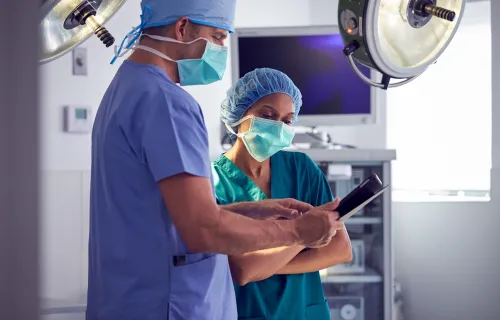 Surgeons looking at tablet device