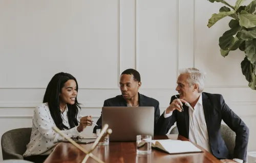 three consultants meeting at conference table