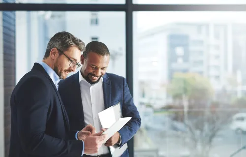 Two consultants discussing on a tablet