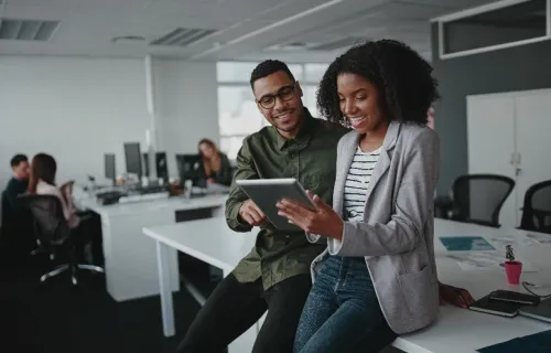 Two cloud consultants look at tablet together